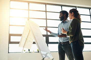 Image showing Mixing bright ideas with a meticulous attention to detail. Shot of two businesspeople brainstorming together in an office.