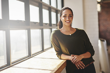 Image showing Self-confidence is everything if you want to become successful. Portrait of a confident young businesswoman standing at a window in an office.