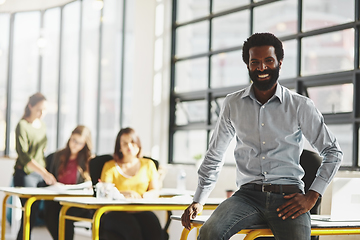 Image showing This is where we make success happen. Portrait of a businessman in an office with his colleagues in the background.