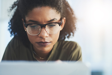 Image showing Persistence and hard work are always key in success. Shot of a young businesswoman busy working on her laptop in a modern office.