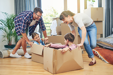 Image showing Getting the family involved boosts family morale. Shot of a happy family having fun together on moving day.