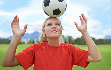 Image showing Its all about balance. Shot of a young female soccer player balancing a ball on her head.