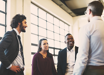 Image showing Catching up with the team. Shot of a team of laid-back businesspeople chatting during their break in the office.