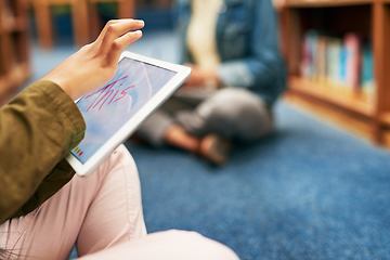 Image showing On a social media study break. Closeup shot of an unrecognisable university student using a digital tablet in the library at campus.