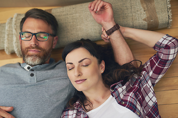 Image showing Nestled into their new home. High angle shot of a couple taking a nap together on moving day.