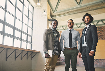 Image showing Were taking the business world by storm. Portrait of three professional businessmen posing together in their office.