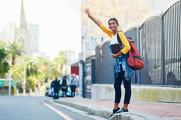 Image showing Got to catch a cab on my way to college. Shot of a young female student commuting to college in the city.