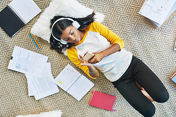 Image showing Taking a music break. High angle shot of a young female student studying at home.