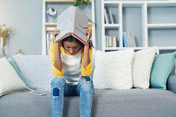 Image showing Stressing about finals. Shot of a young female student studying at home.