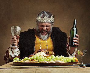 Image showing Im the life of the party. A mature king feasting alone in a banquet hall.