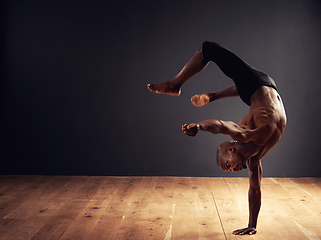 Image showing Dedication, passion, commitment. Male dancer performing an acrobat move.