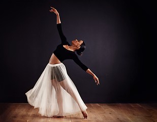 Image showing Elegance personified. Young female contemporary dancer using a soft white white skirt for dramatic effect.