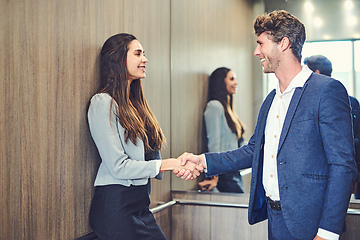 Image showing Its a pleasure meeting you. Cropped shot of a businessman and businesswoman greeting by handshake in an elevator.