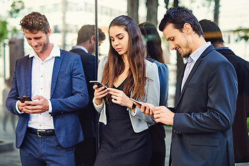 Image showing Enjoying some connectivity outside before they attend the seminar. Cropped shot of businesspeople using cellphones outside.