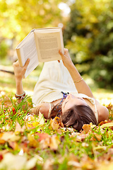 Image showing Autumn beauty. Shot of an attractive young woman in the park on an autumn day.