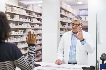 Image showing Have a great day. Shot of a cheerful mature male pharmacist greeting a customer inside of the pharmacy.