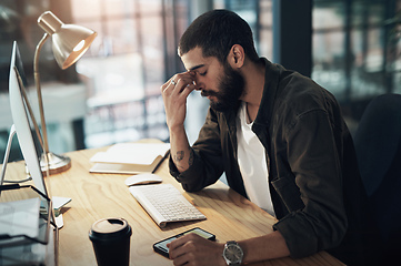 Image showing Thats it, Im done. Shot of a young businessman feeling stressed while working late at night in a modern office.