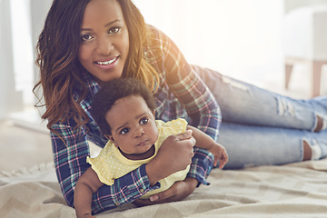 Image showing Shes my everything. Cropped shot of a young mother and her little baby girl at home.