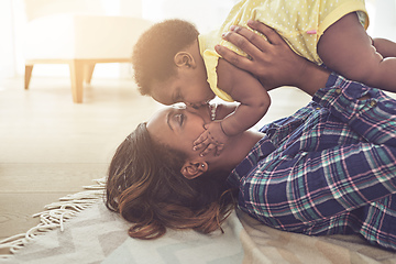 Image showing Happiness is.... Cropped shot of a young mother and her little baby girl at home.