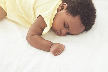 Image showing Sleeping peacefully. Cropped shot of a baby girl asleep on a bed at home.