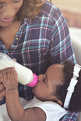 Image showing Drink up. Cropped shot of a young mother feeding her baby girl at home.