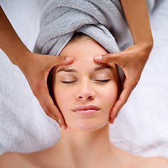 Image showing Letting all her cares melt away. Cropped shot of a young woman enjyoing a massage at the day spa.