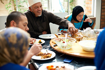 Image showing Food brings family together. Shot of a muslim family eating together.