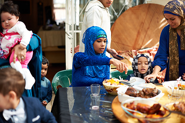 Image showing Food brings everyone together. Shot of a muslim family eating together.