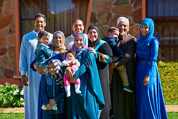 Image showing Theyre one big happy family. Portrait of a happy muslim family standing together in front of their house.