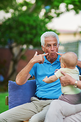 Image showing Take a minute to just stop and play. Shot of a senior man playing with his grandson.