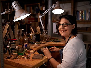 Image showing Where I go to de-stress. Shot of a happy young woman sitting at a workbench.