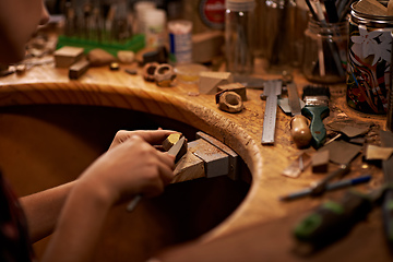 Image showing The skills my father taught me. A person using a tool to work on a piece of wood.