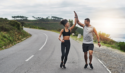 Image showing What an amazing run that was. Shot of a sporty young couple high fiving each other while exercising outdoors.