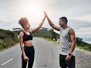 Image showing Were crushing so many of our fitness goals. Shot of a sporty young couple high fiving each other while exercising outdoors.