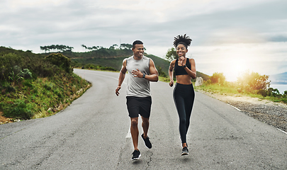 Image showing Clocking some workout time in the fresh air. Shot of a sporty young couple exercising together outdoors.