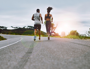 Image showing Staying in top form together. Rearview shot of a sporty young couple exercising together outdoors.