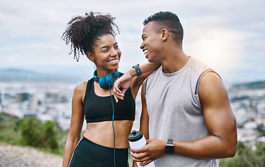 Image showing Living well leads to true happiness. Shot of a sporty young couple taking a break while exercising outdoors.