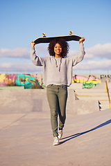 Image showing Why walk when you can skate. Shot of a young woman out skateboarding in the city.