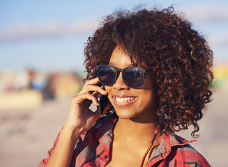 Image showing Im here.. wanna meet up. A trendy young african american woman smiling while using her mobile.