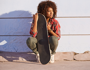 Image showing Why walk when you can skate. Shot of a young woman out skateboarding in the city.