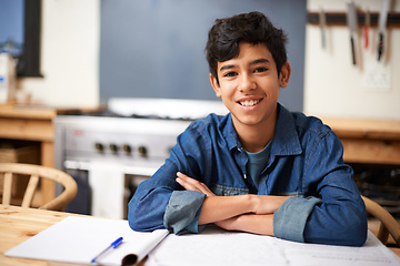 Image showing Im top of my class. Portrait of a young boy studying at a desk in a classroom.