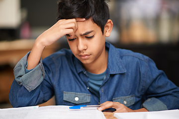 Image showing Is there a solution to this algebra problem. Shot of a young teenage boy studying at a desk.