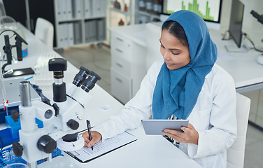 Image showing Getting down to life enhancing lab work. Shot of a young scientist using a digital tablet while conducting research in a laboratory.