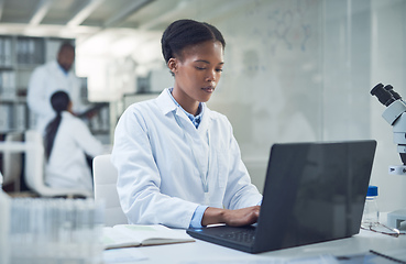 Image showing The harder she works, the closer the cure. Shot of a young scientist using a laptop while conducting research in a laboratory.