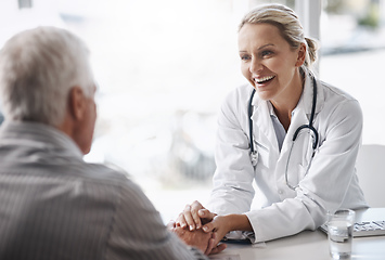 Image showing Im glad to see youre in such great health. Cropped shot of a mature female doctor working with a senior male patient in her office in the hospital.