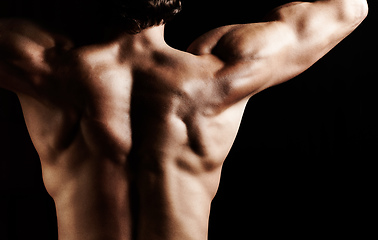 Image showing Masculinity in portrait. Studio shot of a muscular shirtless man isolated on black.