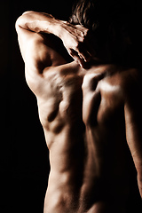 Image showing Masculinity in portrait. Studio shot of a muscular shirtless man isolated on black.