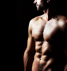 Image showing Masculinity in portrait. Studio shot of a muscular shirtless man isolated on black.