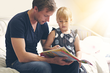 Image showing Hes always there for her. Shot of a single dad helping his daughter with her homework.