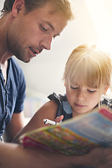 Image showing Dedicated to his daughter. Shot of a single dad helping his daughter with her homework.